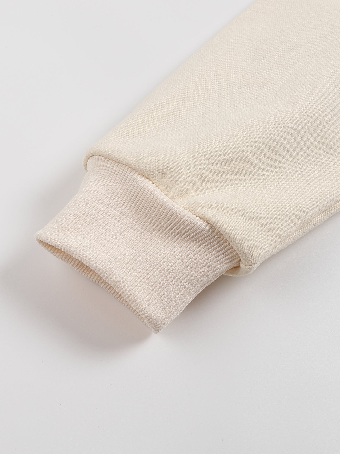 Close-up of a beige fabric sleeve on a light gray background