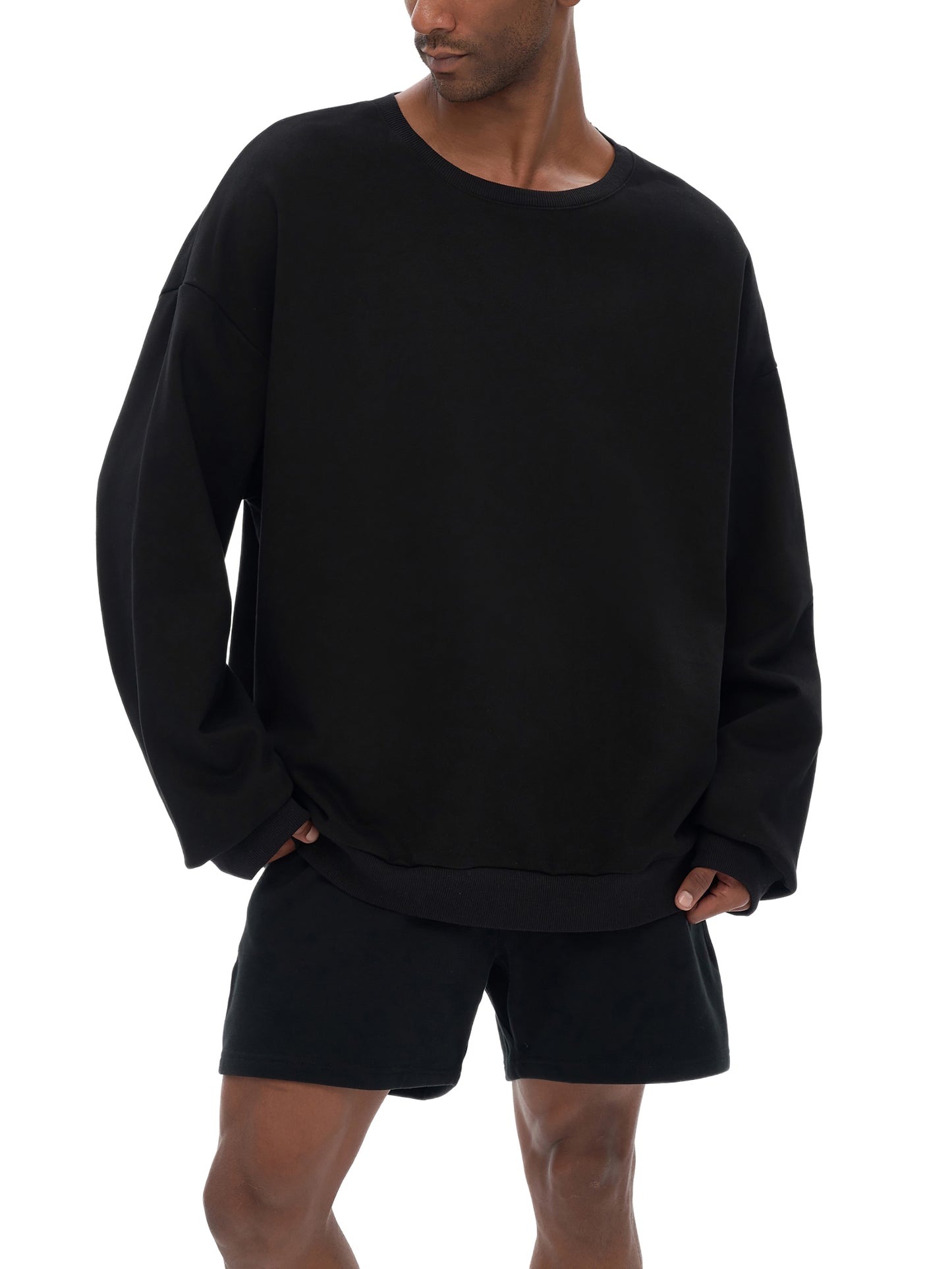Model wearing VÉRON oversized streetwear sweater in urban setting 1