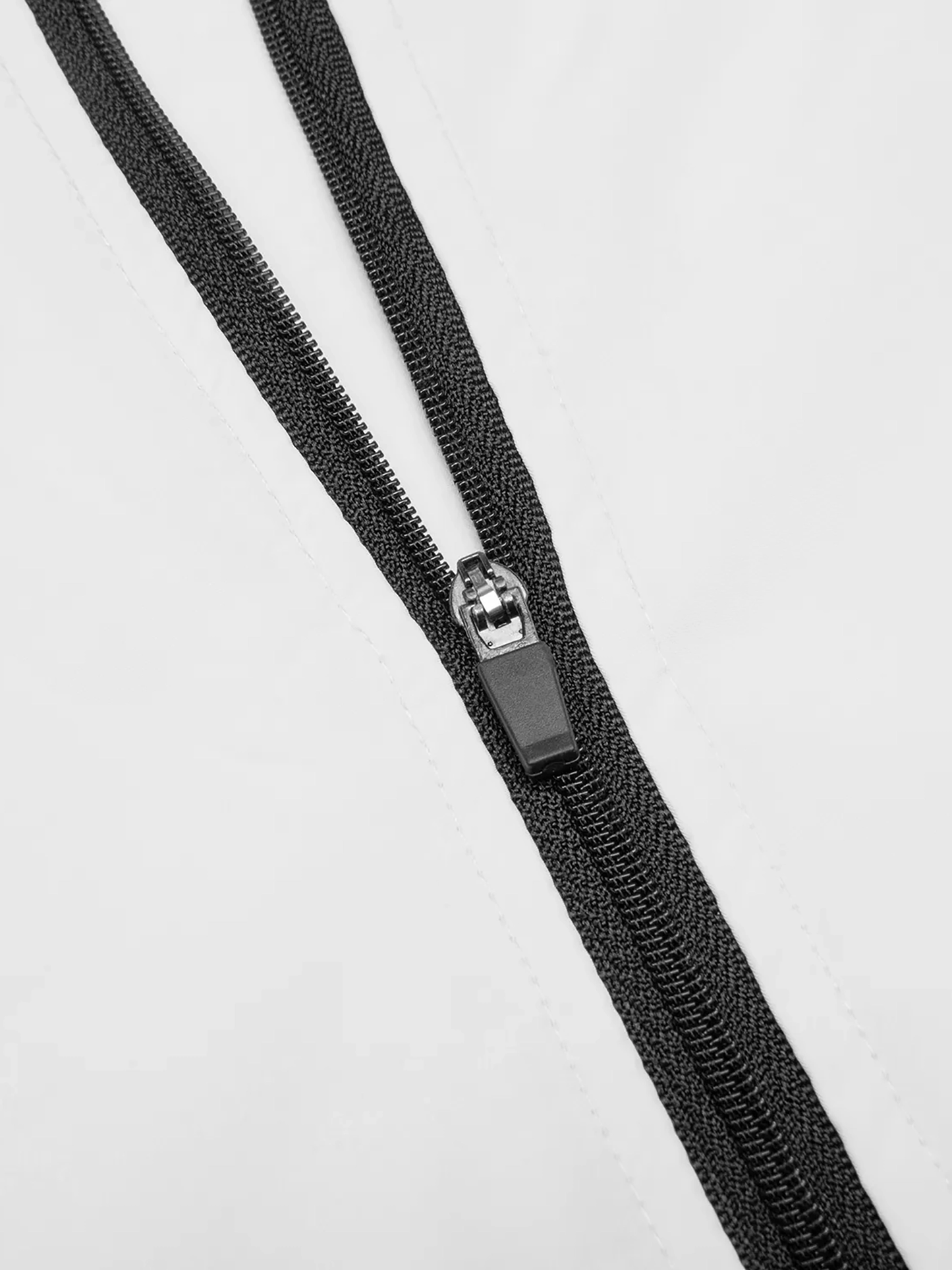 Close-up of VÉRON jacket zipper and fabric texture 2.