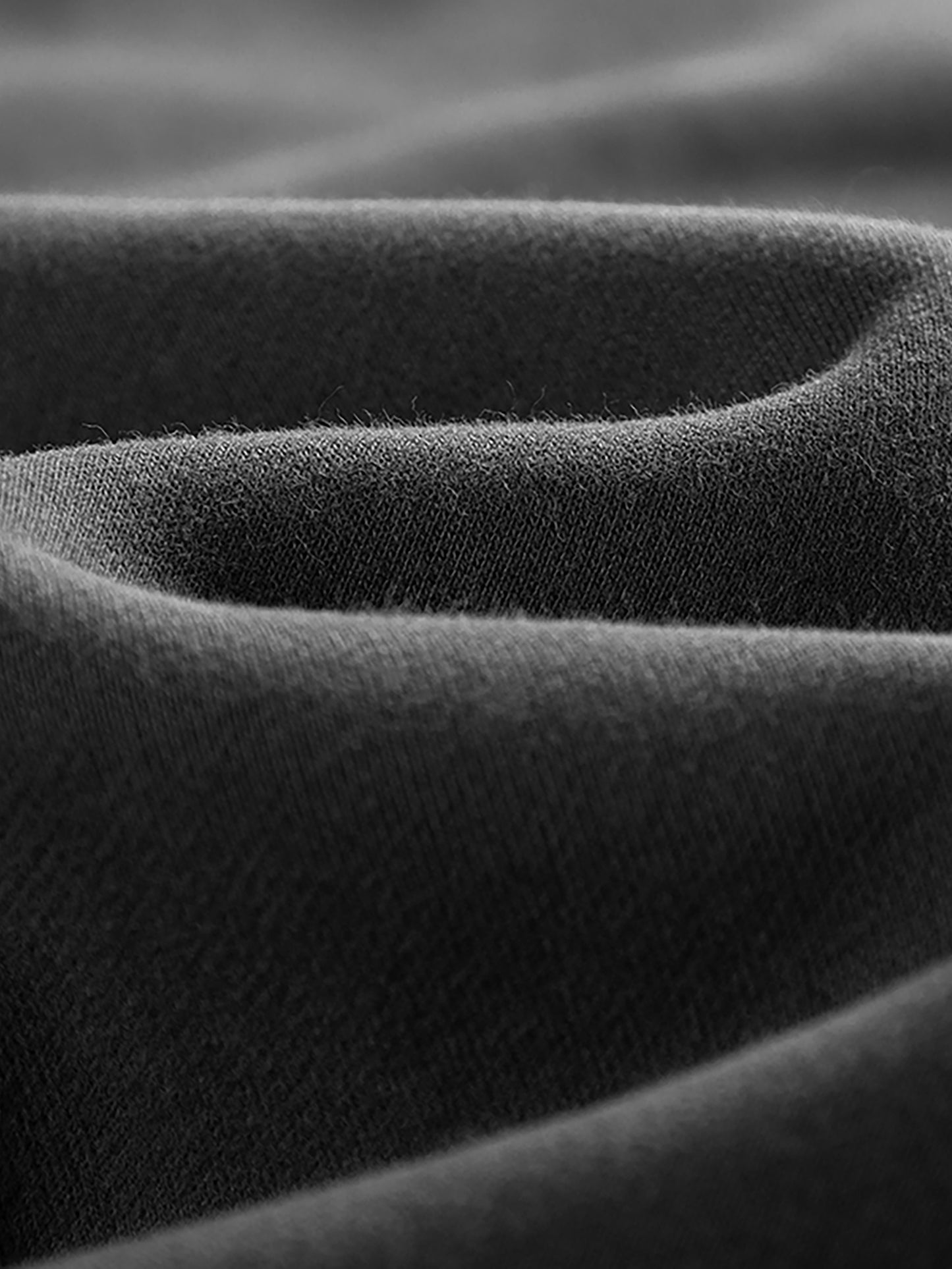 Close-up of dark gray fabric with a textured pattern