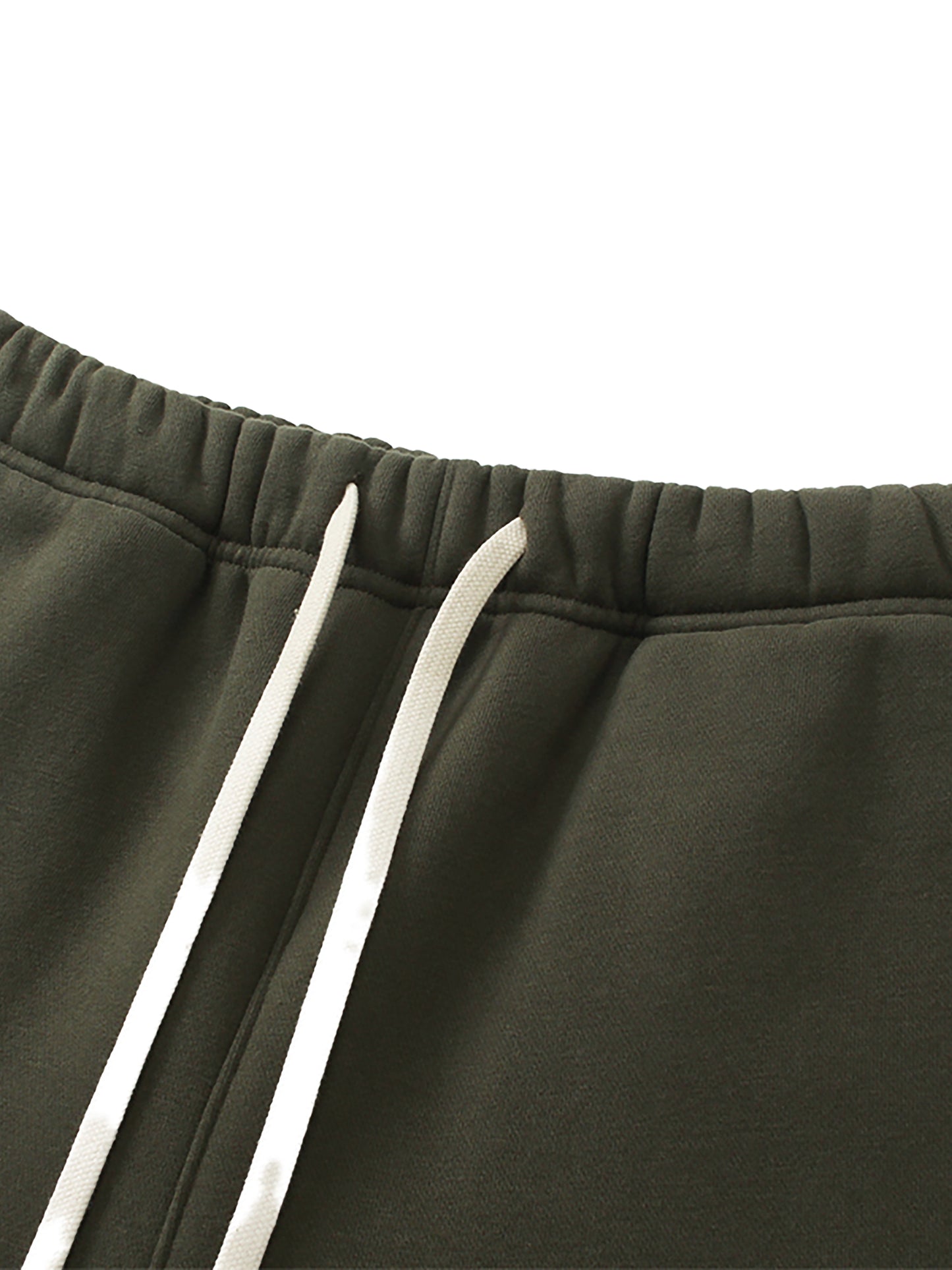 Close-up of dark green pants with white drawstring on a white background