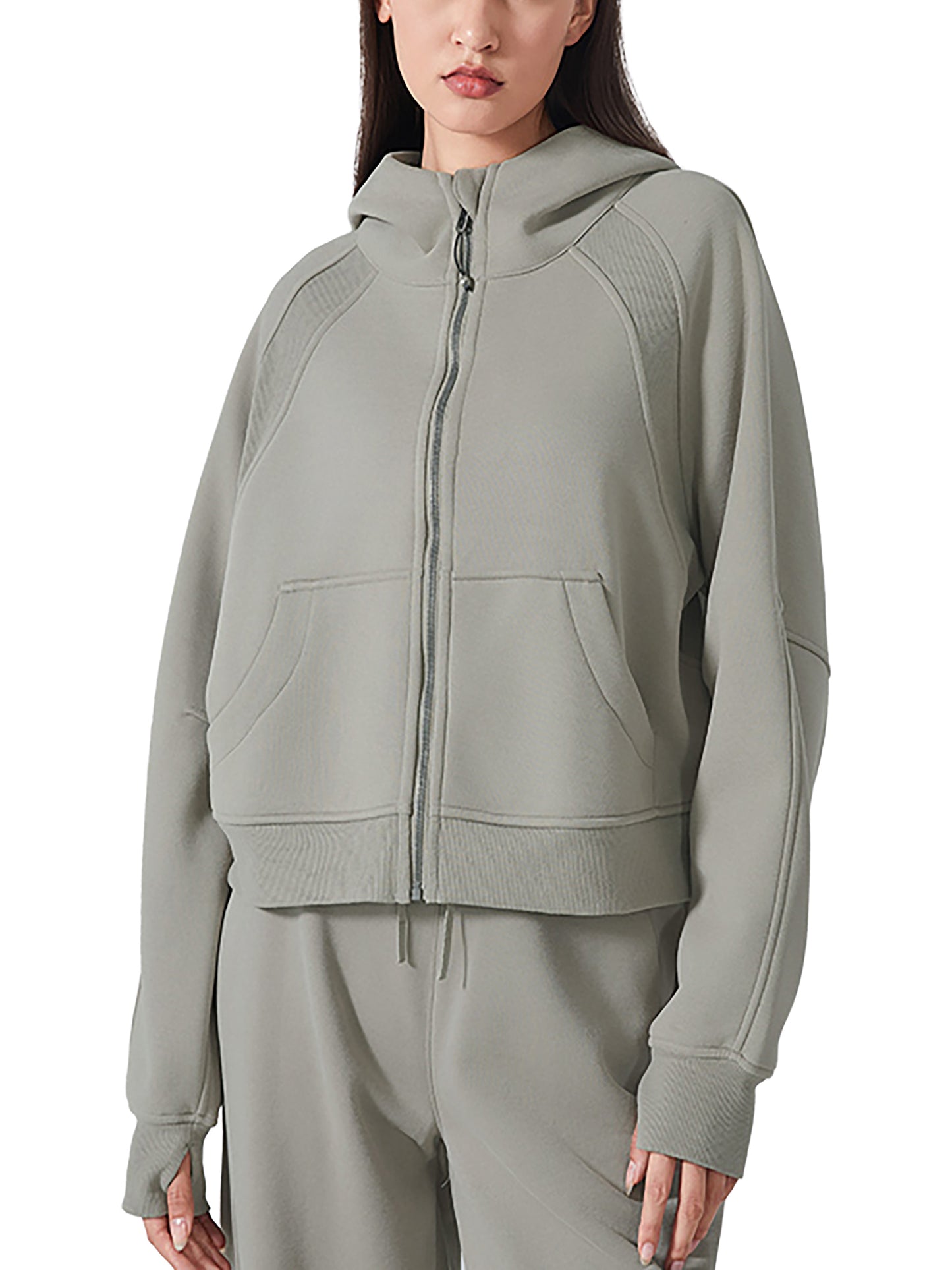 Person wearing a gray zip-up hoodie on a white background