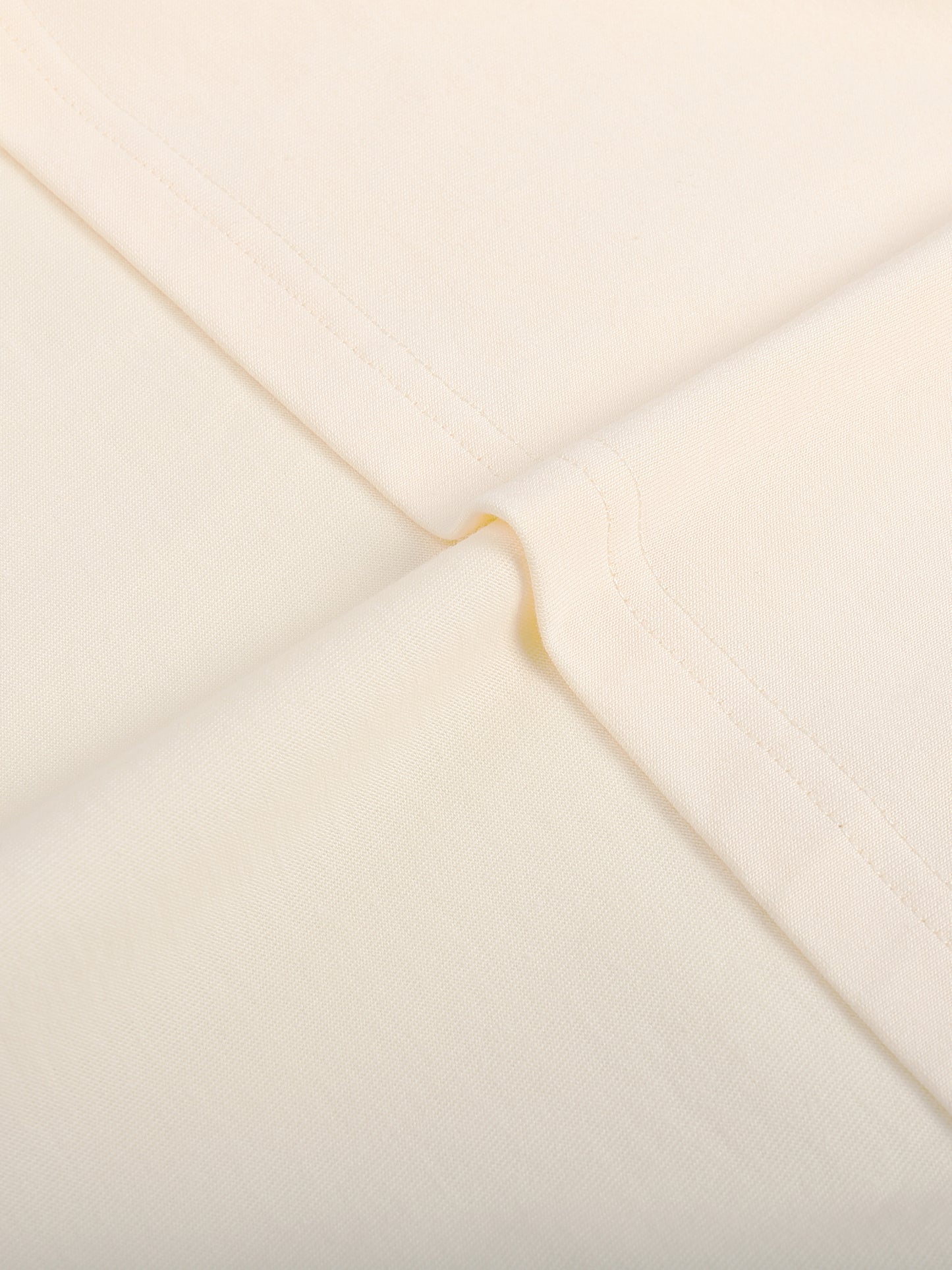 Close-up of a beige envelope with a gold flap