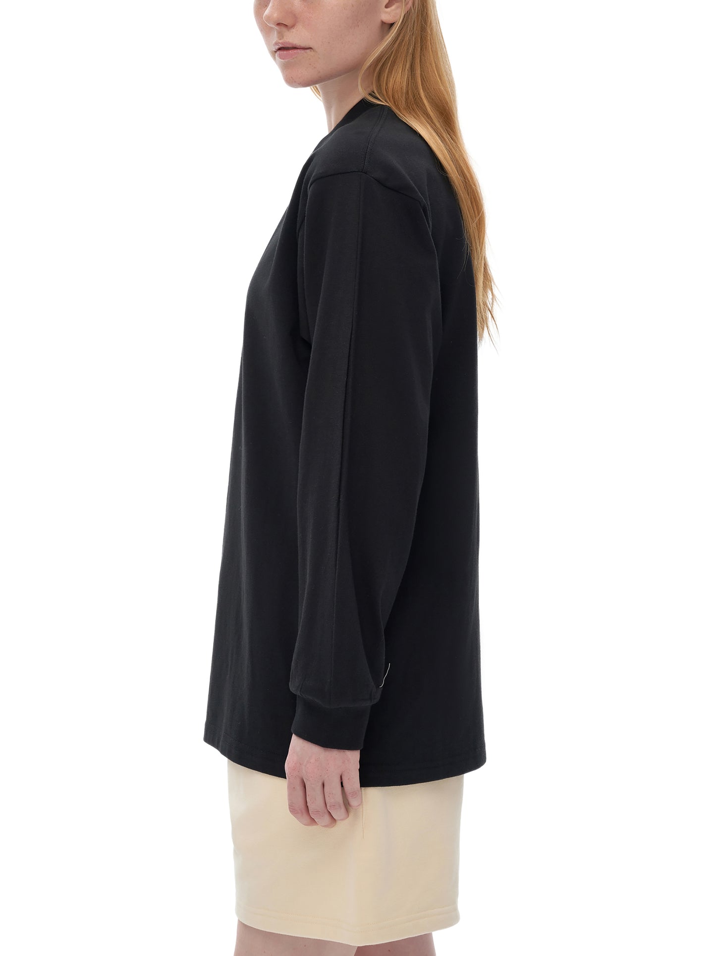 Person wearing VERON black oversized sweatshirt with a plain background