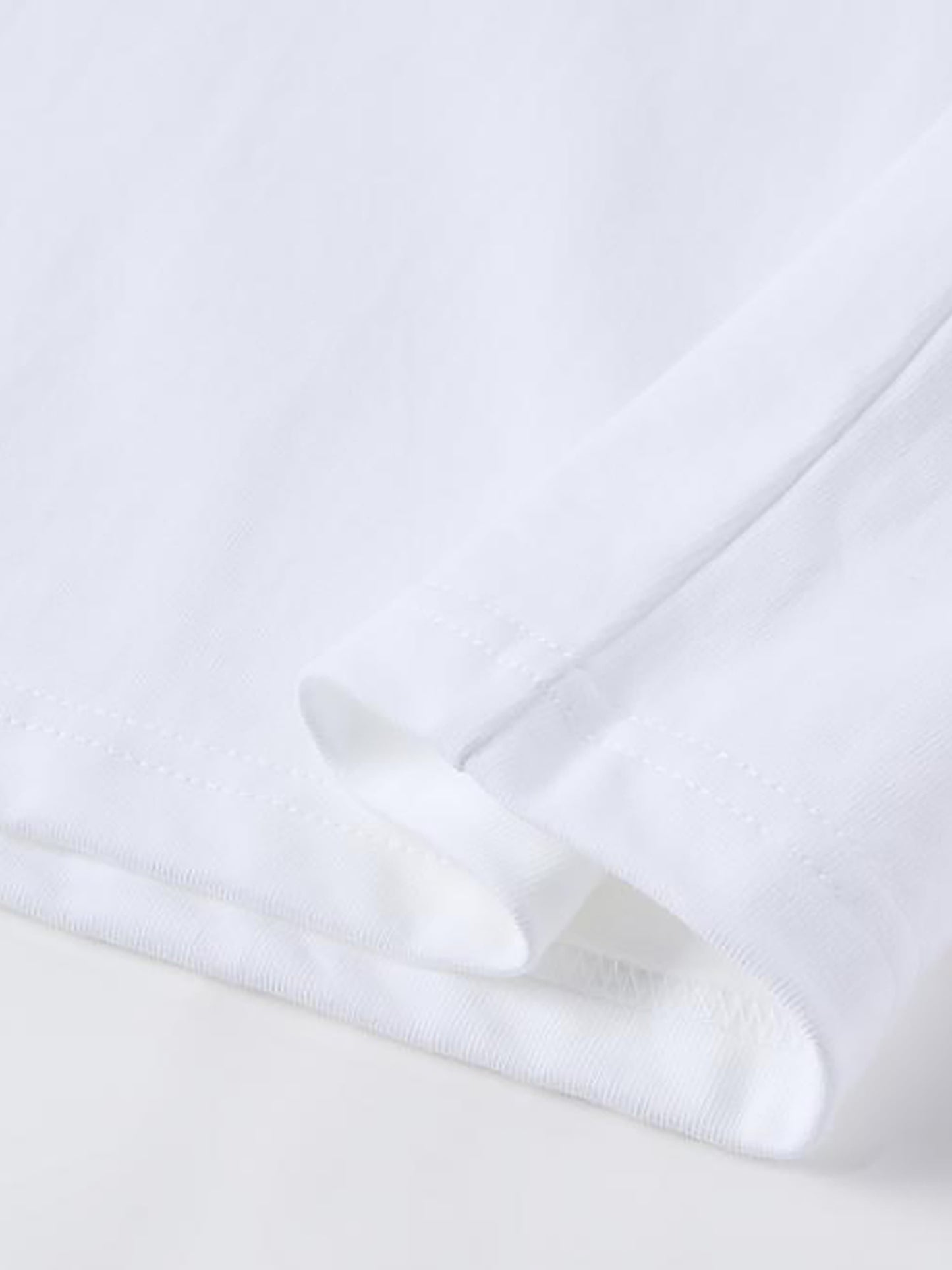 Close-up of a white shirt with a collar on a light gray background