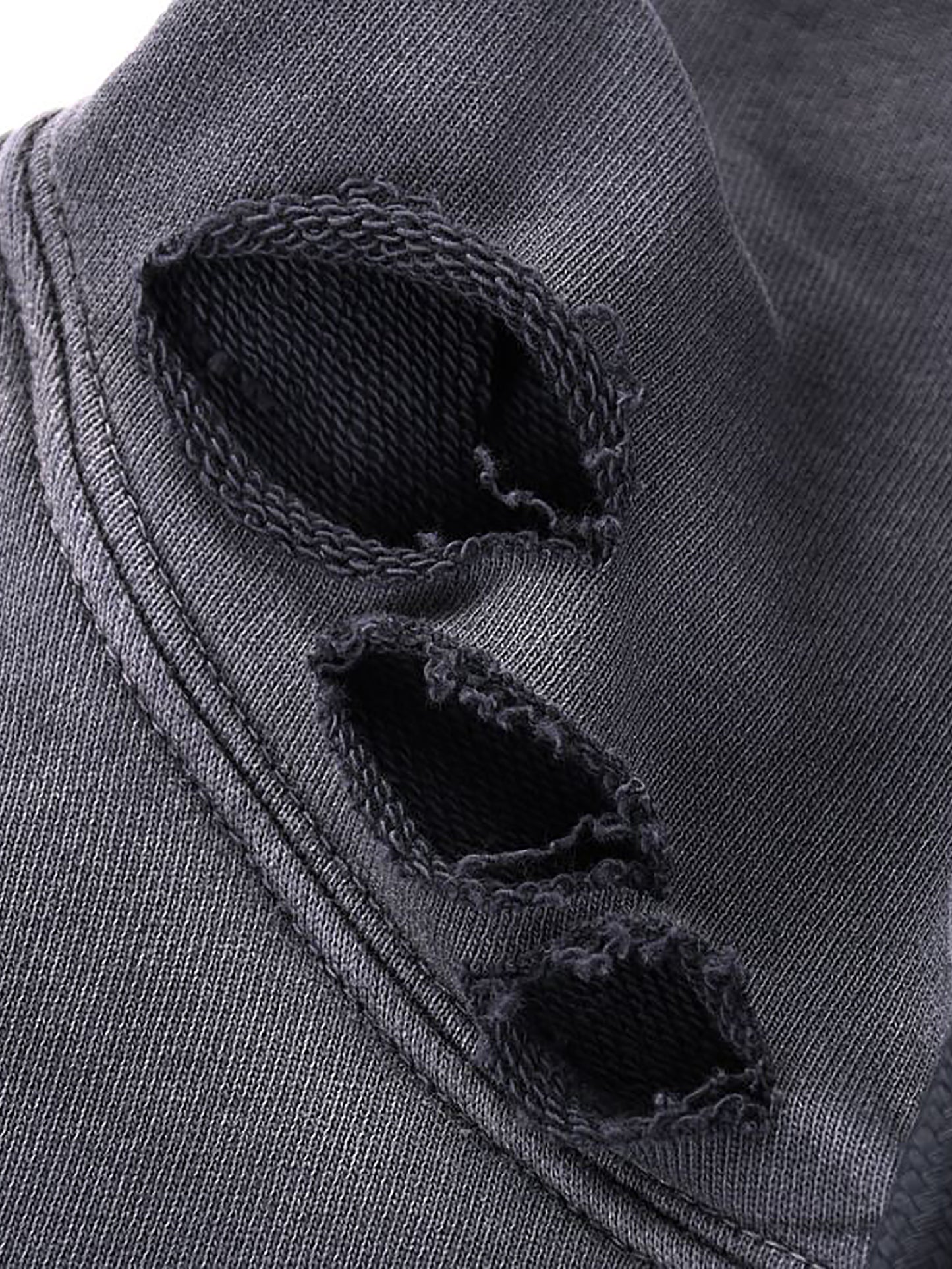 Close-up of a dark gray fabric with frayed edges