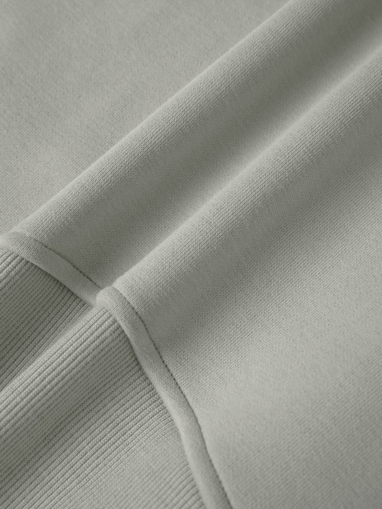 Close-up of light gray fabric with ribbed texture