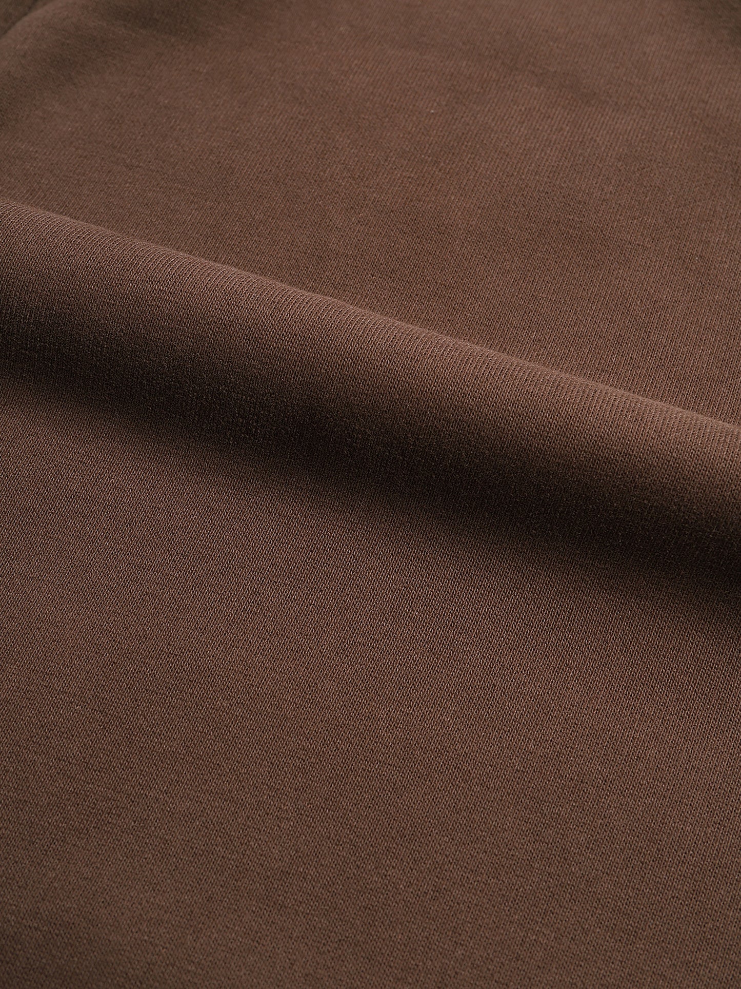 Close-up of brown fabric with a subtle texture