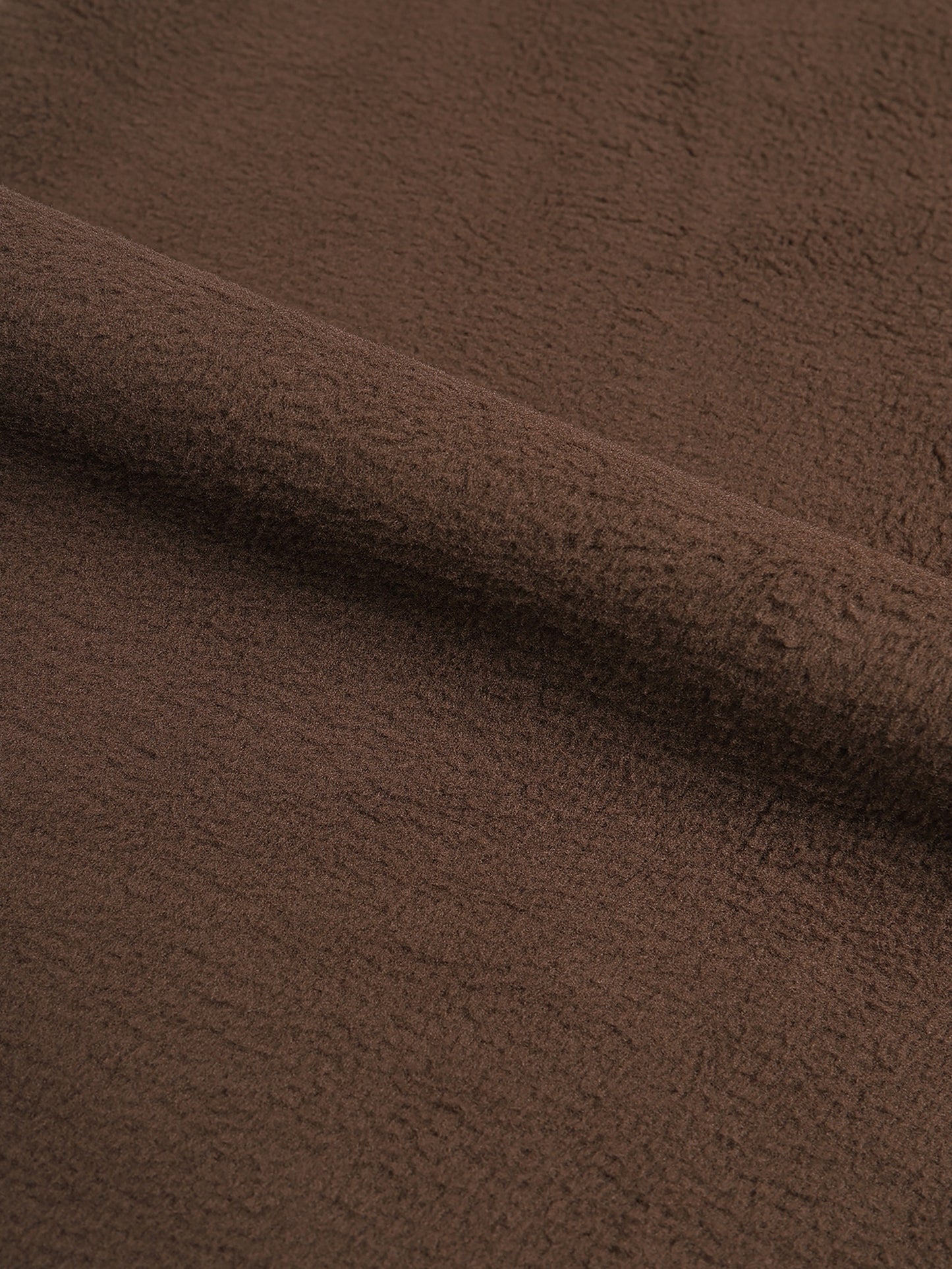 Close-up of brown fabric with a soft texture.