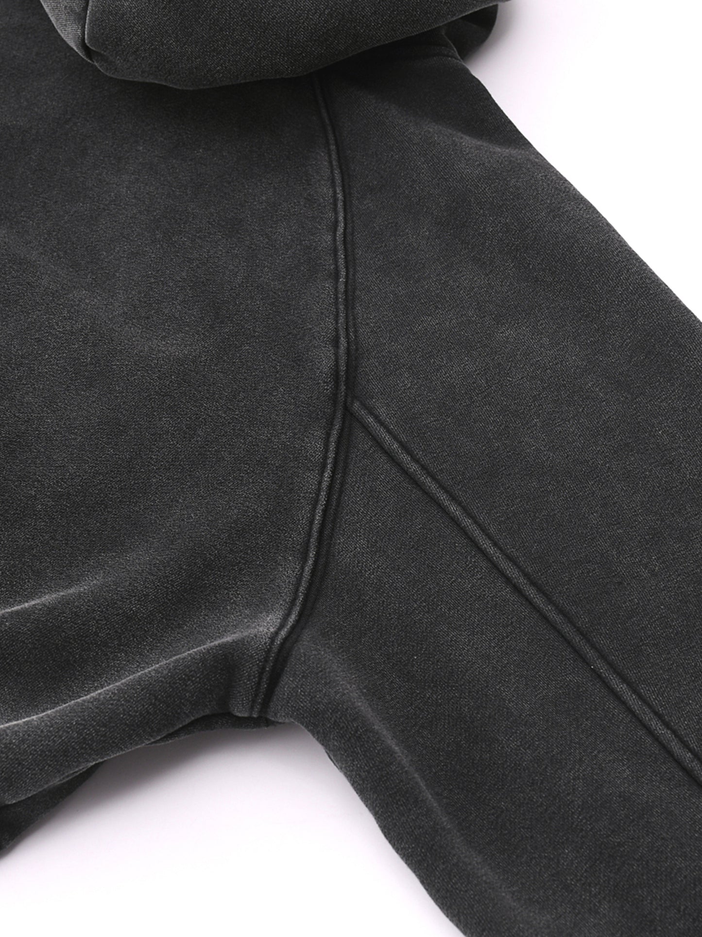 Close-up of a dark gray hoodie on a white background