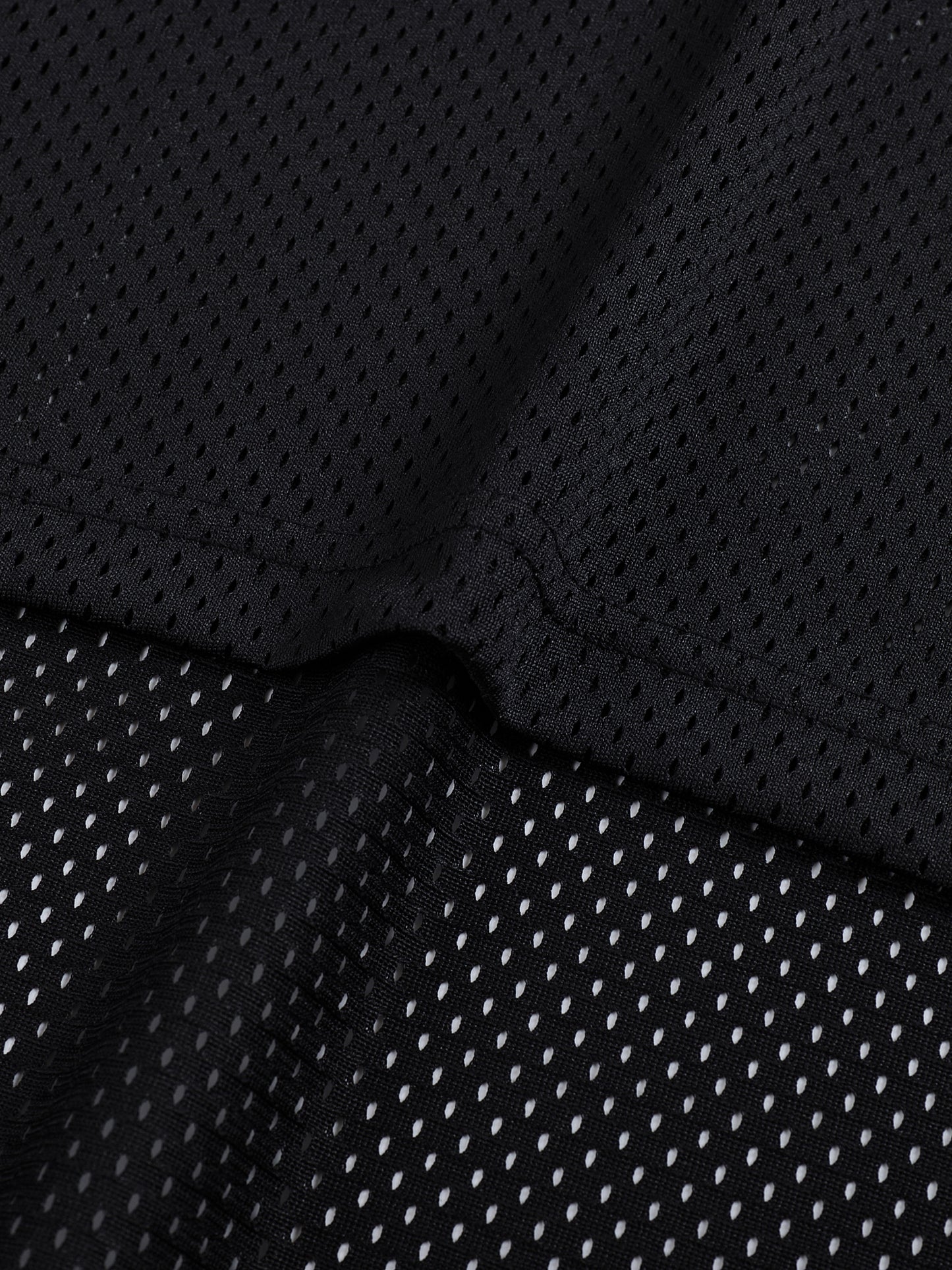 Close-up of black jersey shirt textured fabric with a subtle pattern
