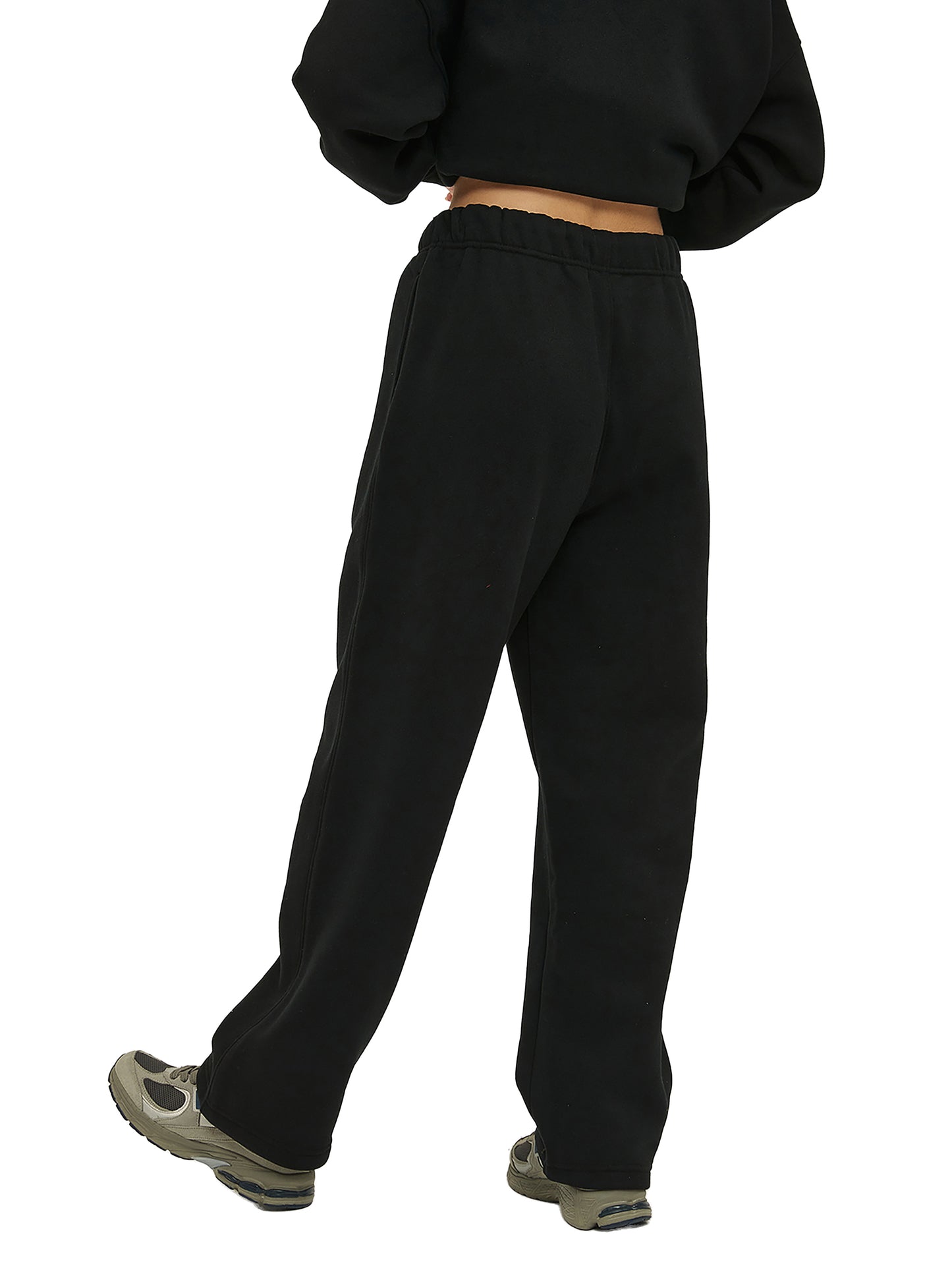 Person wearing black sweatpants on a white background