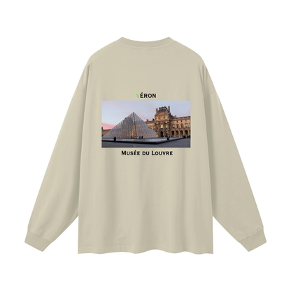 Beige long-sleeve shirt with a graphic of the Louvre Museum on the back.