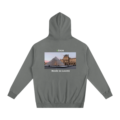 Gray hoodie with a printed design on the back featuring the Louvre Museum.