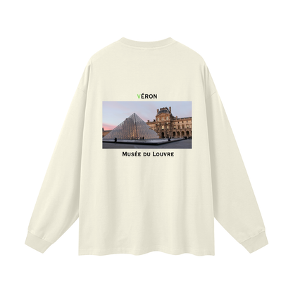 Beige long-sleeve shirt with a graphic of the Louvre Museum on the back.