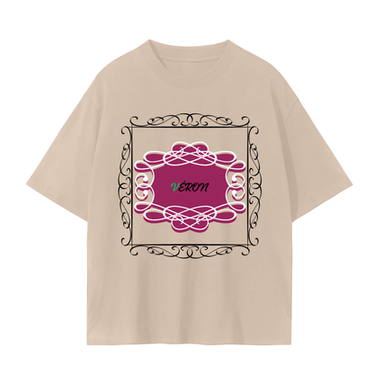 Beige t-shirt with decorative pink and black design on a white background
