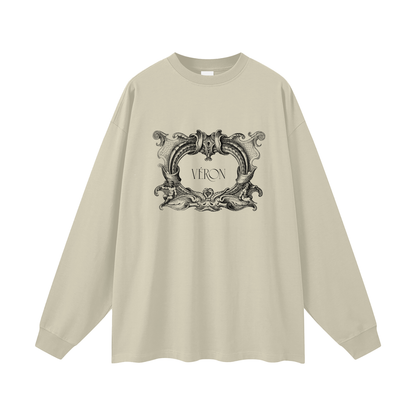 Beige long-sleeve shirt with decorative graphic and 'VERON' text on a white background