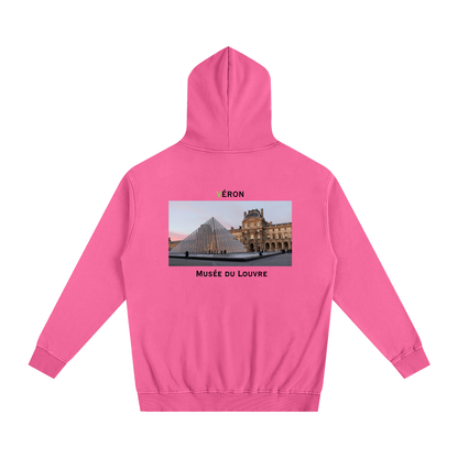 Pink hoodie with a graphic of the Louvre Museum on the back