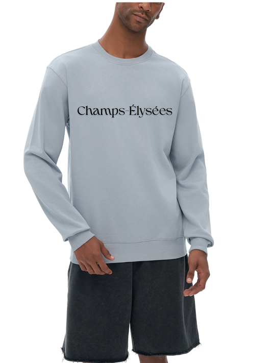 Person wearing a light gray sweatshirt with 'Champs Elysees' text on a white background