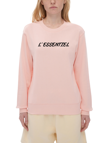 Person wearing a pink sweatshirt with 'L'ESSENTIEL' text on a white background