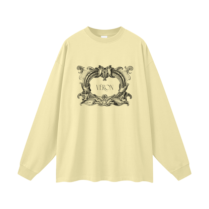 Beige long-sleeve shirt with decorative graphic and 'VERON' text on a white background