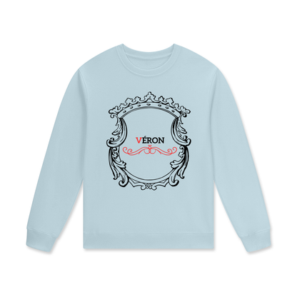 Light blue long-sleeve shirt with decorative emblem and 'Véron' text on a white background