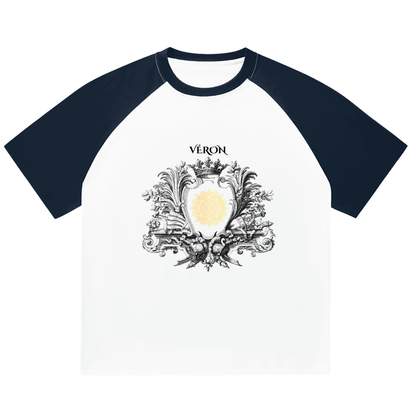 Navy and white T-shirt with decorative emblem and 'Véron' text on a white background