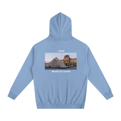 Light blue hoodie with a graphic of the Louvre Museum on the back