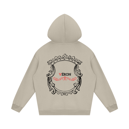 Beige hoodie with decorative back design and 'Véron' text on a white background
