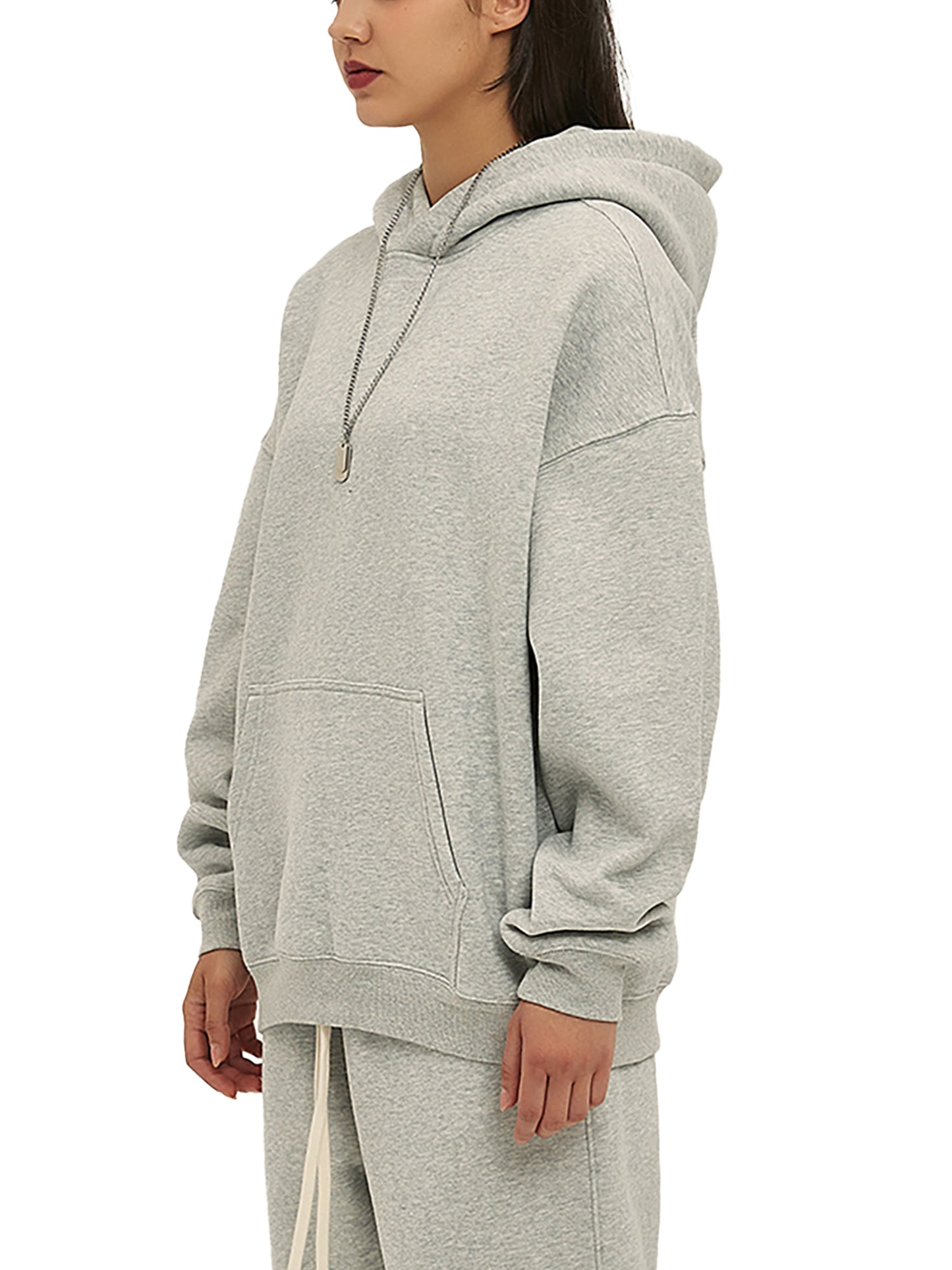 Person wearing a gray hoodie on a white background