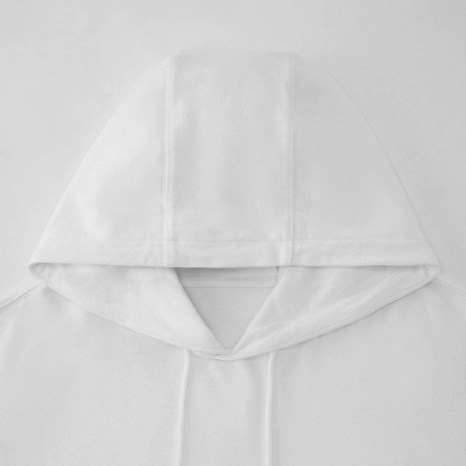 Close-up of a white hooded garment on a light gray background