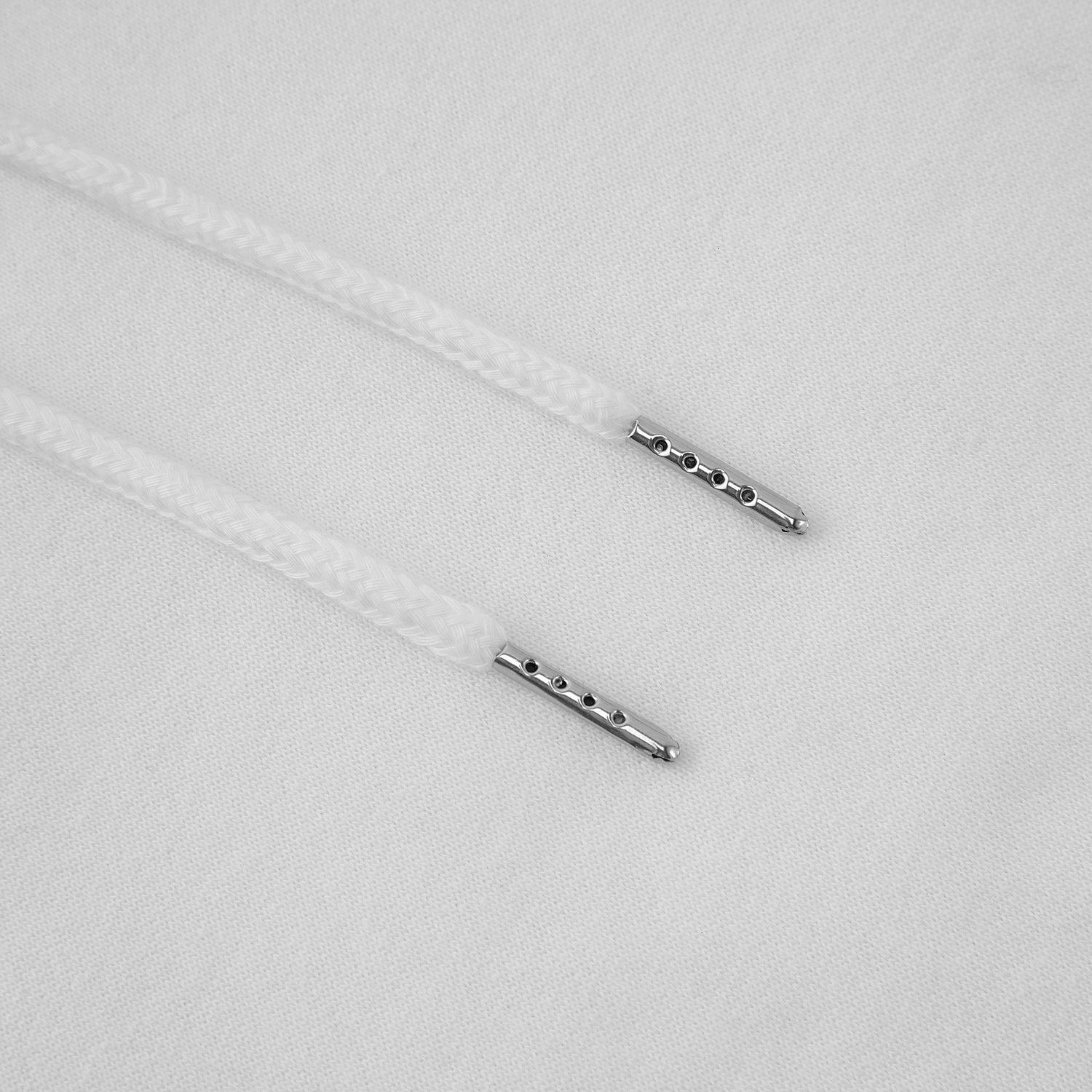 Close-up of metal eyelets on a white fabric background