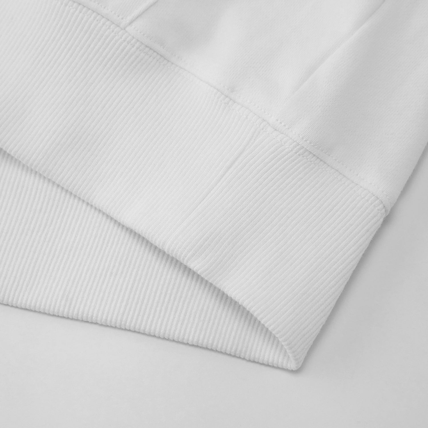 Close-up of a light gray quilted fabric on a matching background