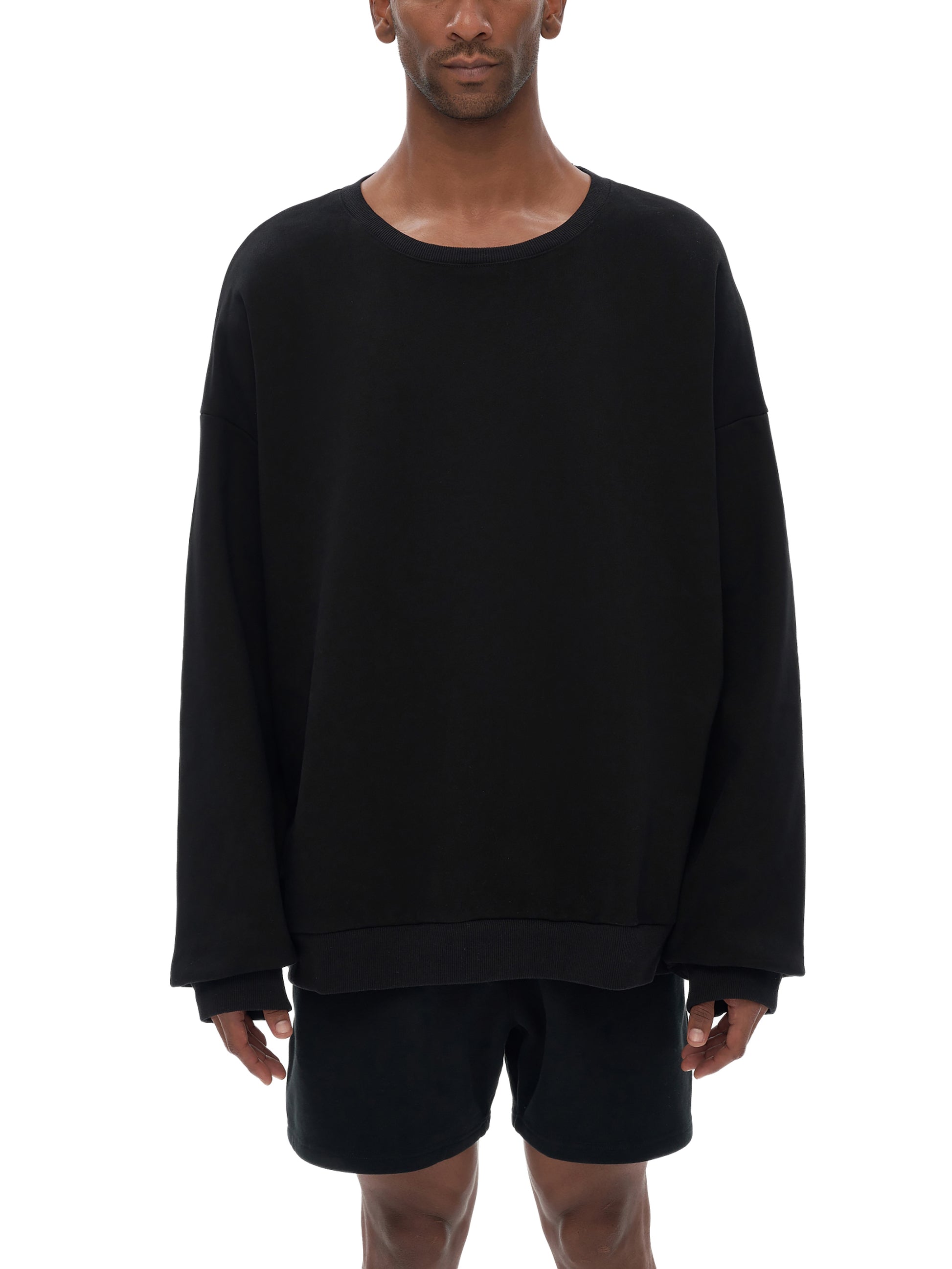 Model wearing VÉRON oversized streetwear sweater in urban setting 2