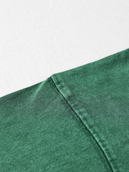 Close-up of a green fabric edge on a light gray background
