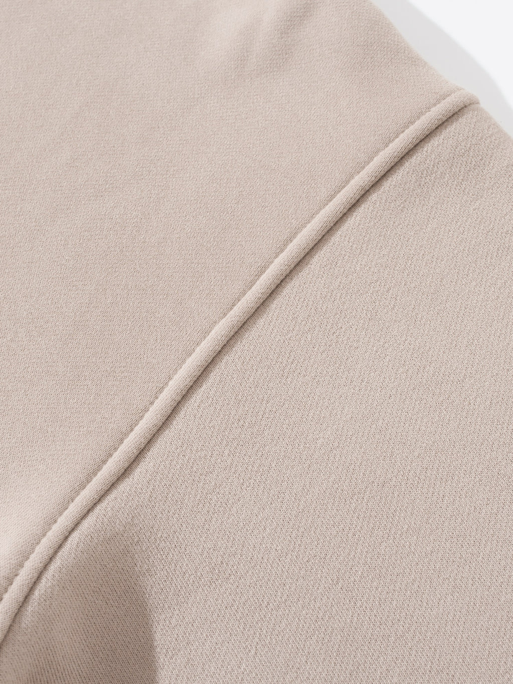 Close-up of beige fabric with a seam