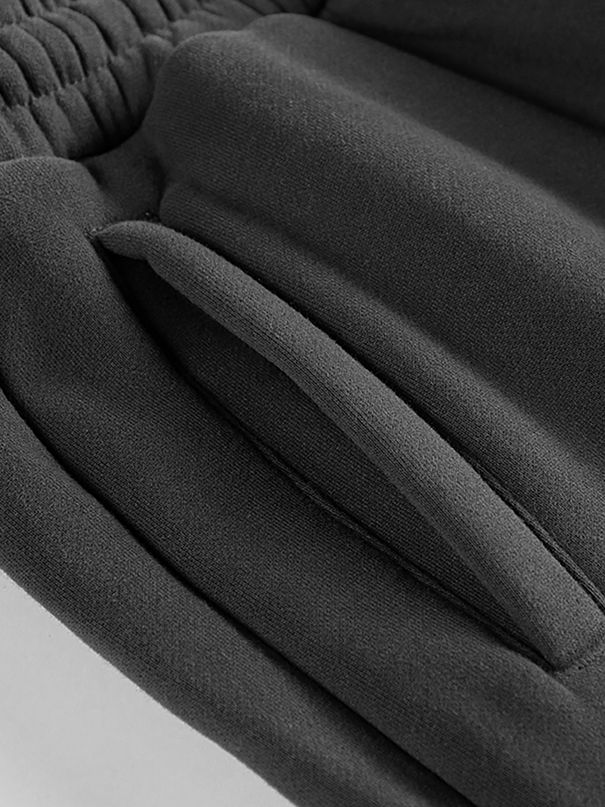 Close-up of black fabric texture on a light gray background