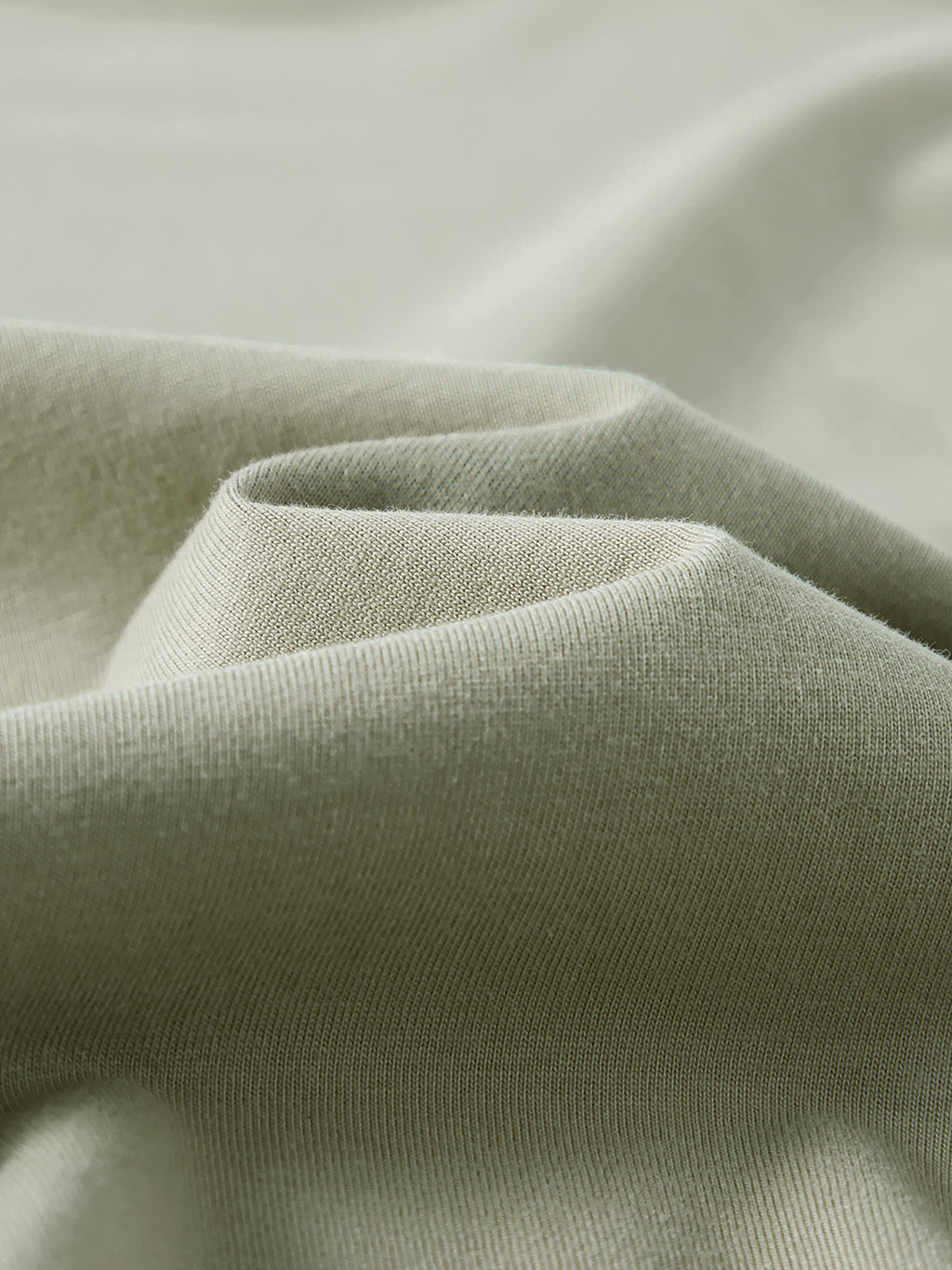 Close-up of green fabric with a soft texture