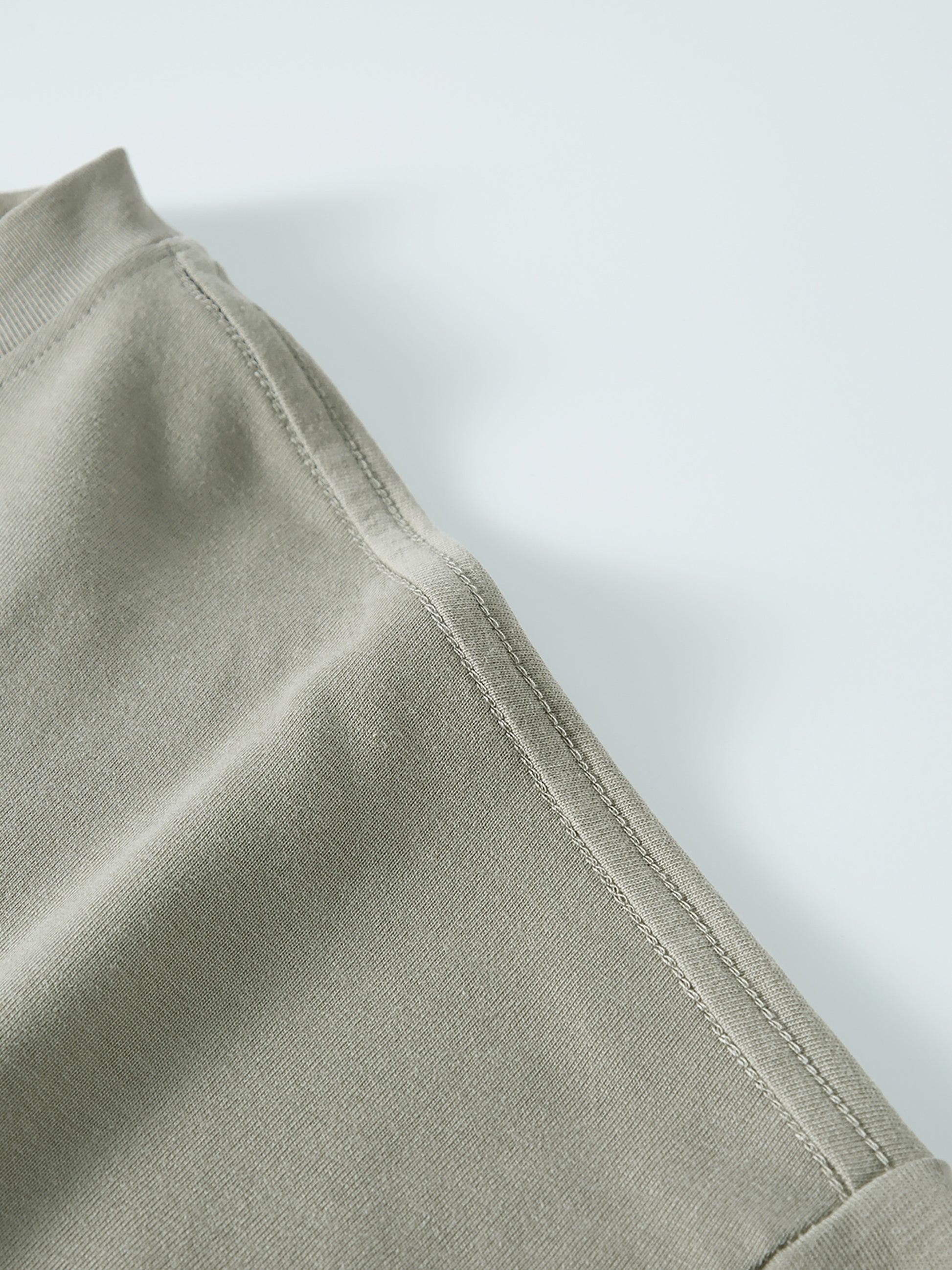 Close-up of a light green fabric with a white background