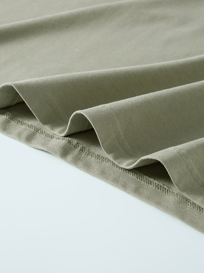 Close-up of a folded green fabric on a light gray background