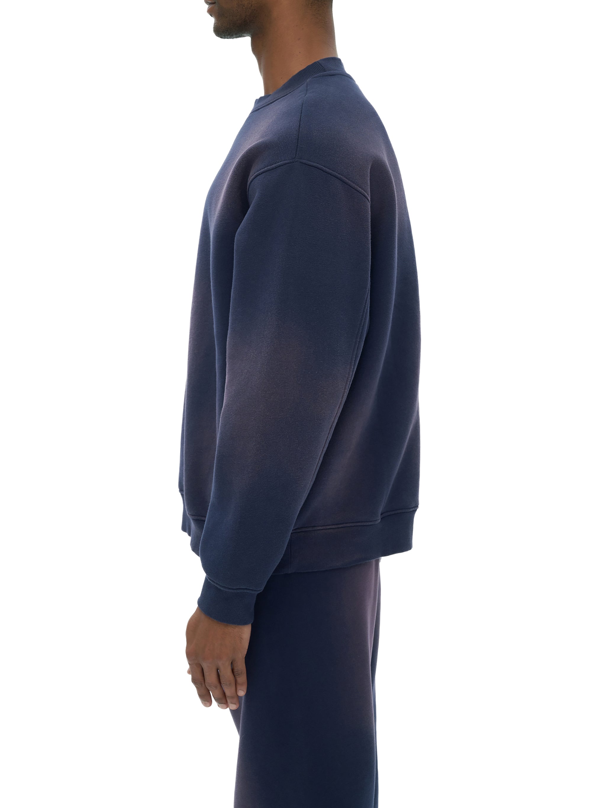 Model wearing VÉRON Rue de l’Université crewneck in urban setting 3