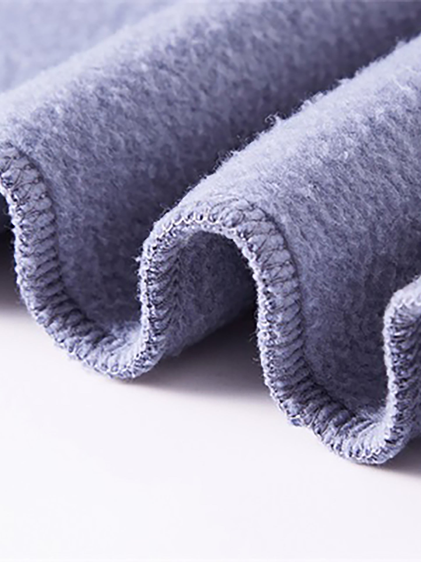 Close-up of a textured blue fabric roll on a white background