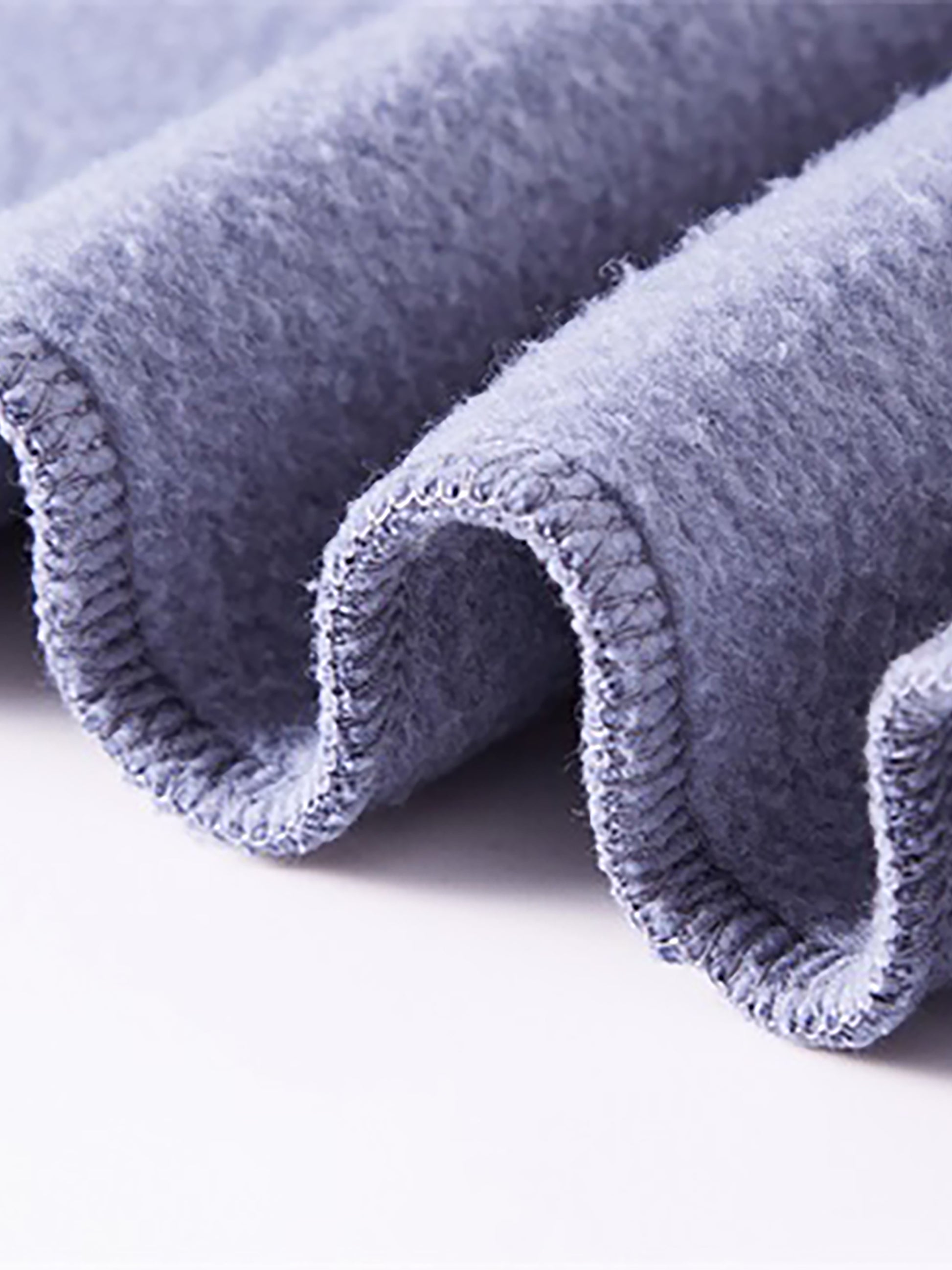 Close-up of a textured blue fabric roll on a white background