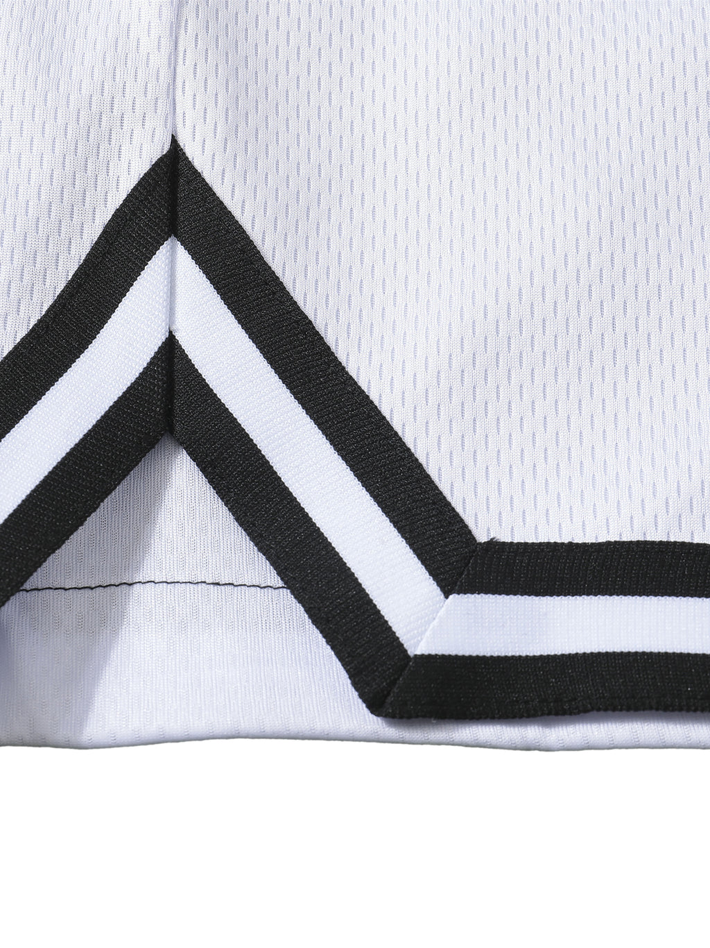 Close-up of a white short with black and white striped trim on a white background