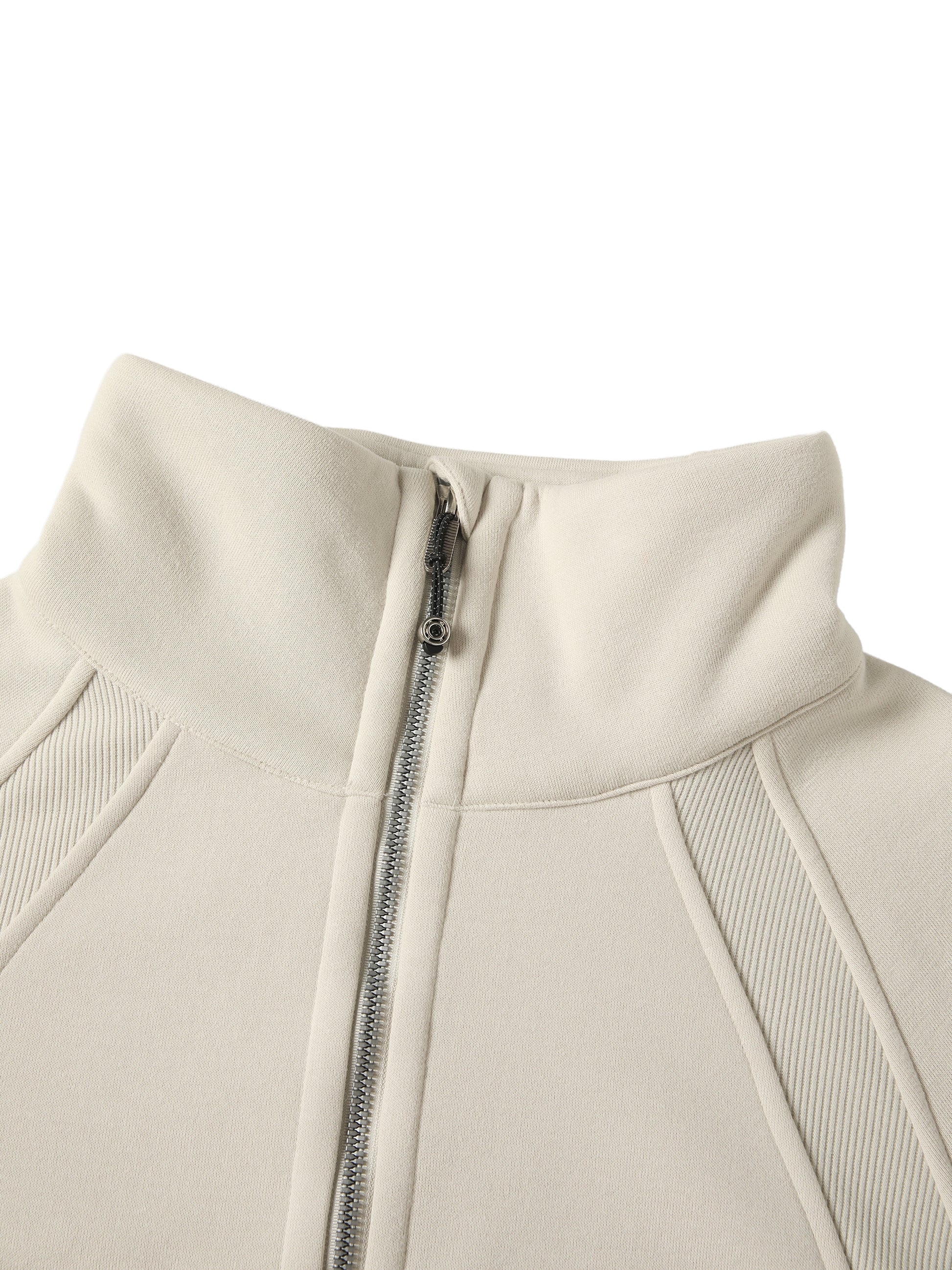 Close-up of a beige jacket with a zipper on a white background