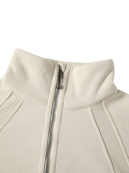 Close-up of a beige jacket with a zipper on a white background