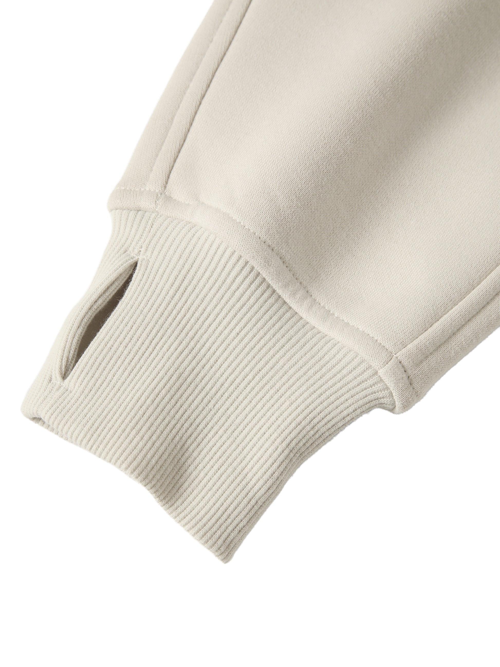 Close-up of a beige sweater sleeve on a white background