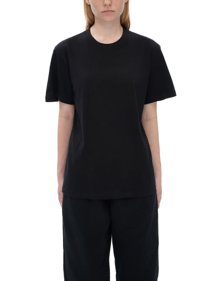 Person wearing a black t-shirt and pants on a white background