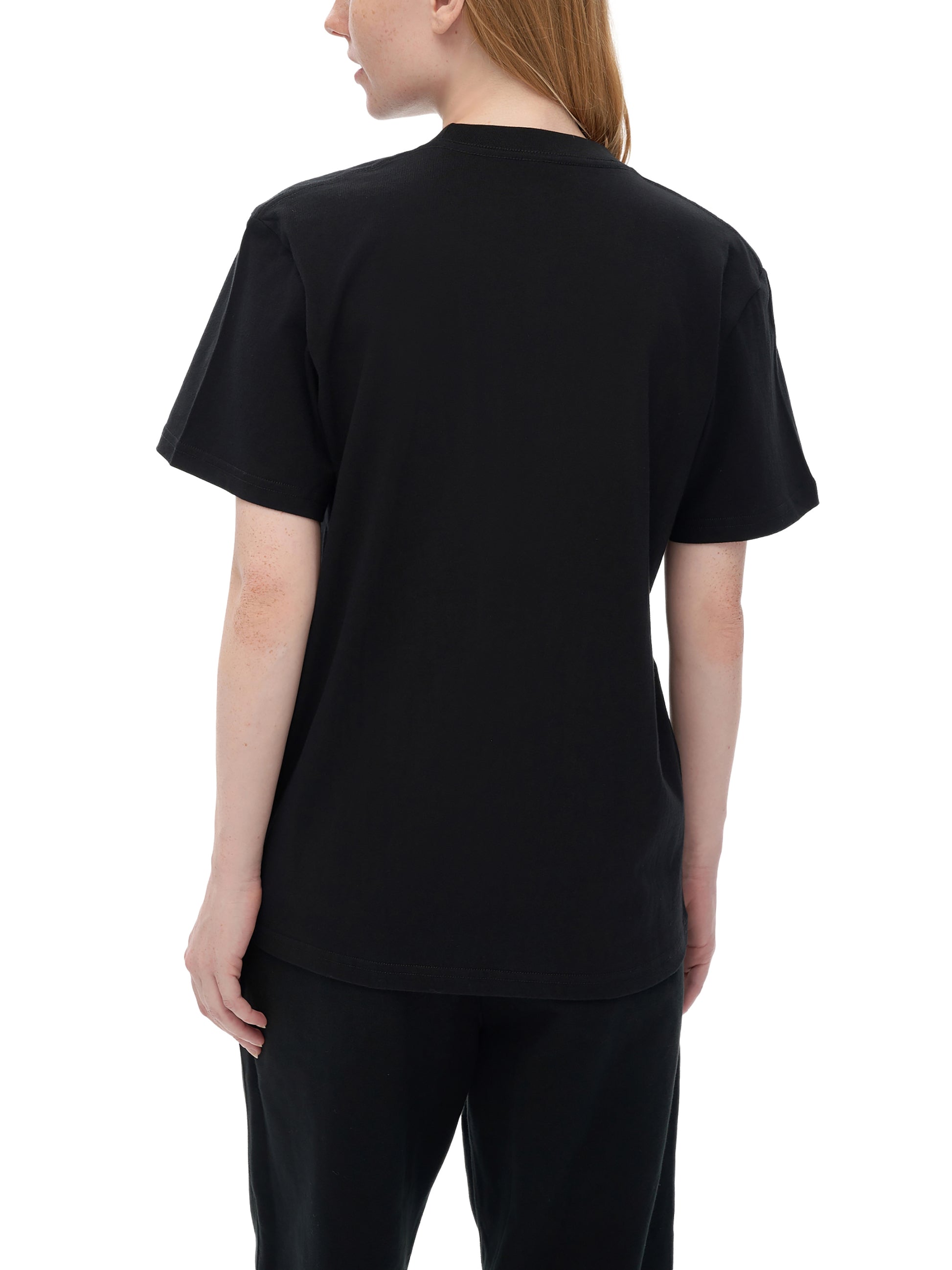 Person wearing a black t-shirt and pants on a white background