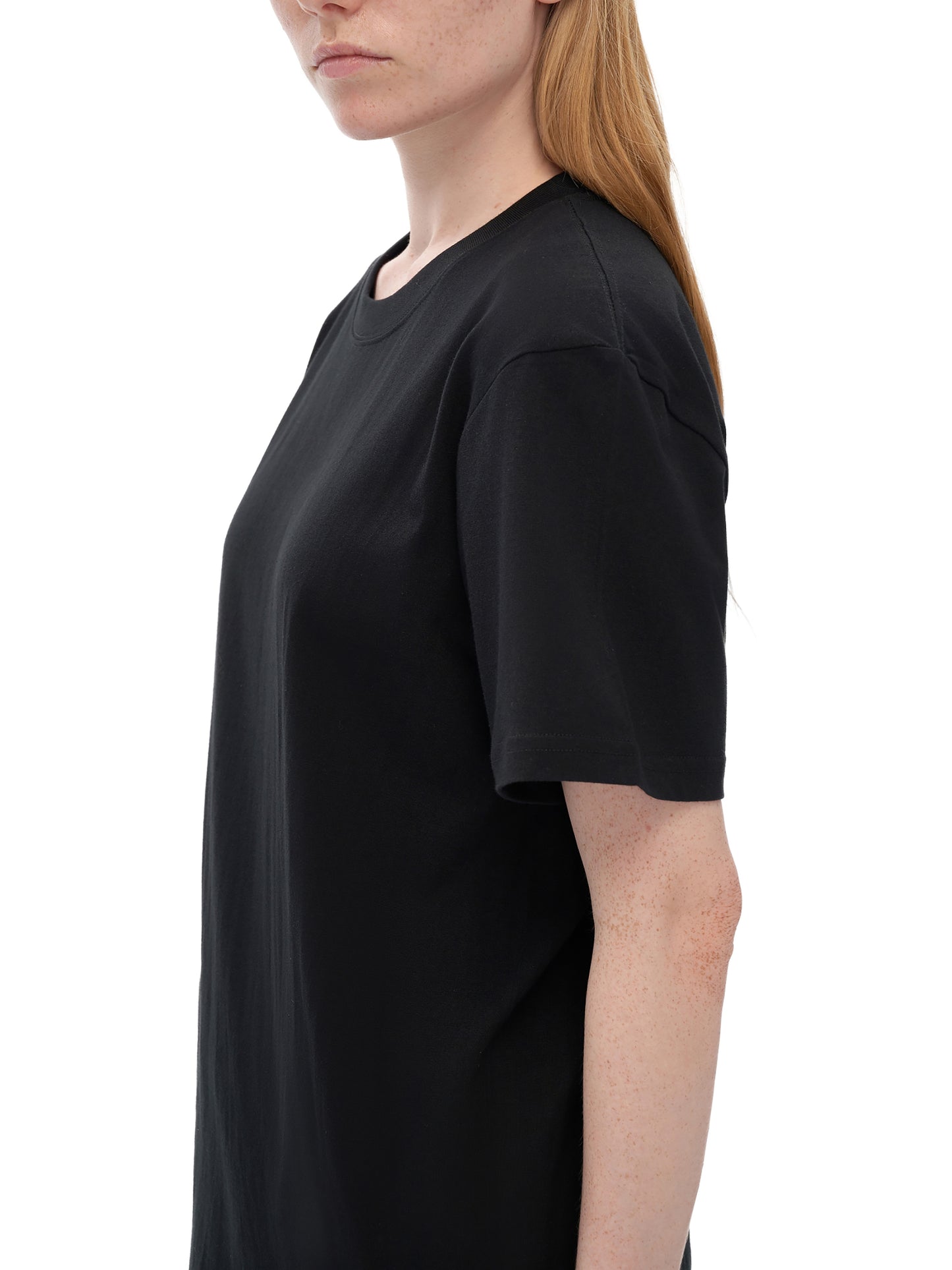 Person wearing a black t-shirt on a white background